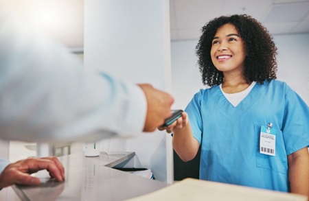 Healthcare worker accepts cashless payment for services