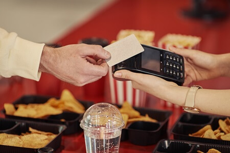 Cashless cinema rewards program being scanned at concessions stand